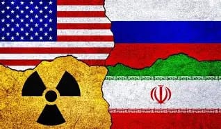 A U.S. naval vessel patrolling Middle Eastern waters at dusk, symbolizing heightened military posture amid rising tensions with Iran.